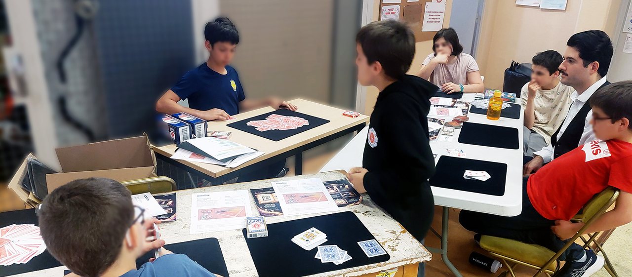 Élèves pratiquant un tour de cartes sur tapis de close-up pendant un atelier